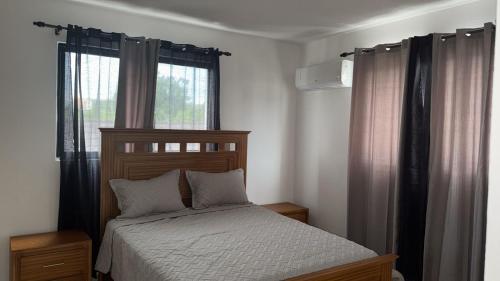 a bedroom with a bed and a window at Residencial HH in Santiago de los Caballeros