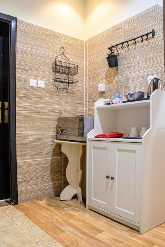 a kitchen with a counter and a bird cage on the wall at Waha Grand Residance in Medina
