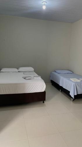 two beds sitting next to each other in a room at Vila Aconchego in Bragança