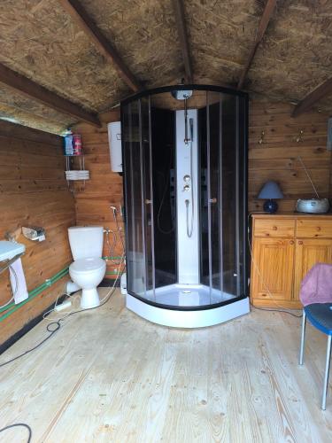 a large glass shower in a room with a toilet at BeauCamp in Rhodes