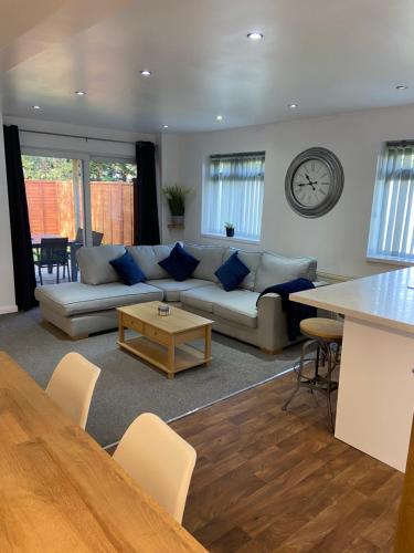 a living room with a couch and a table at Wyndham studio in Uphill
