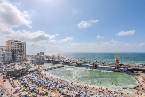 an aerial view of a beach with people and the ocean at Nabeel Homes - Panoramic Seaview Condo in Stanley in Alexandria