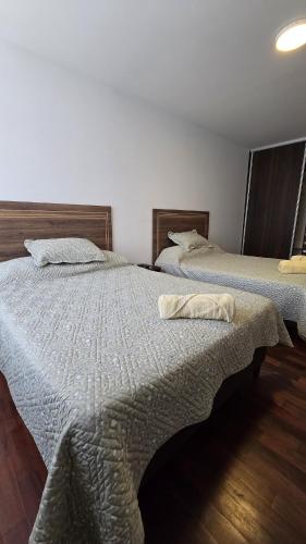 two beds sitting next to each other in a room at Garzonier in the best area of Cochabamba in Cochabamba