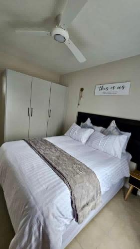 a bedroom with a large white bed in a room at Bliss Ballito 2 in Ballito