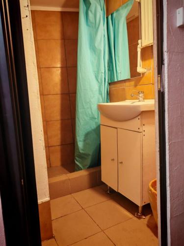 a bathroom with a sink and a shower with a tub at Apartament muncitori in Bacău