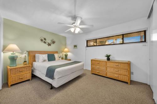 a bedroom with a bed and a ceiling fan at Sugar Beach 511 in Kihei