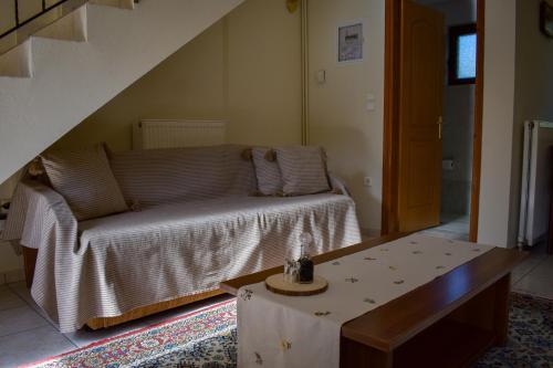 a living room with a couch and a table at Artemis Mezonetes in Kalavrita