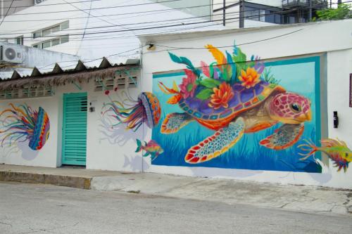 a mural of a turtle on the side of a building at The Boat House Cancun in Cancún