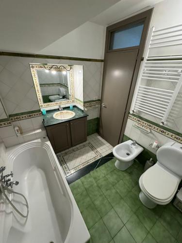 a bathroom with a tub and a toilet and a sink at IL moro in Acireale