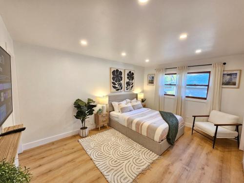 a bedroom with a bed and a chair at Modern Retreat near Six Flags & Naval Base in Waukegan