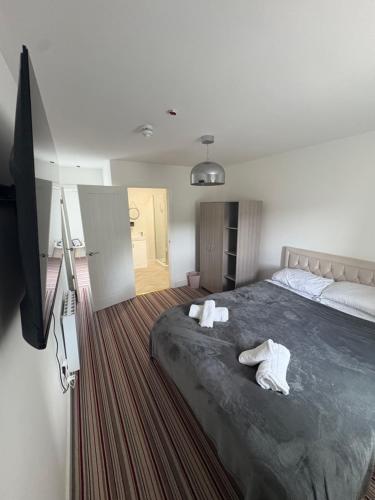 a bedroom with a bed with two towels on it at Pentwyn avenue apartment in Mountain Ash