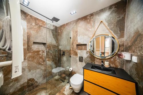 a bathroom with a sink and a mirror at Appartement avec salle de cinema in Agadir