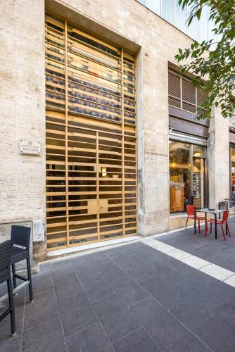 a store front with a large window with wooden blinds at La bella napoli house casa vacanze con 3 camere da letto in Naples