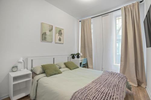 a white bedroom with a bed and a window at 2BD Comfy Manhattan Home in New York