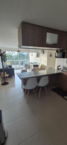 a kitchen with a table and chairs in a room at Condominio Parque Mar El Tabo in El Tabo