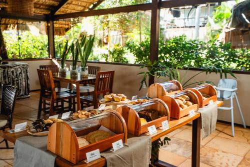 a display of breads and pastries on a table at Bangalô Kauli Seadi Eco-Resort in São Miguel do Gostoso