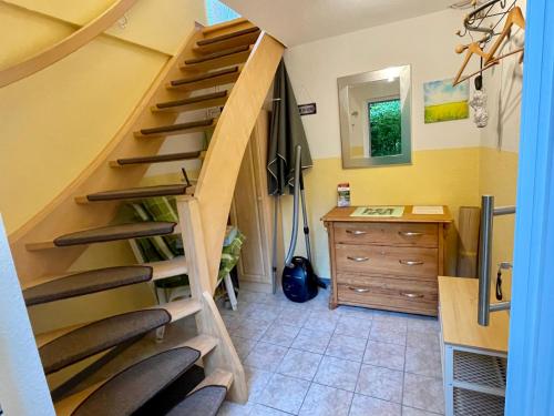 a staircase in a room with chairs and a desk at Fewo Auszeit Schwanow in Rheinsberg