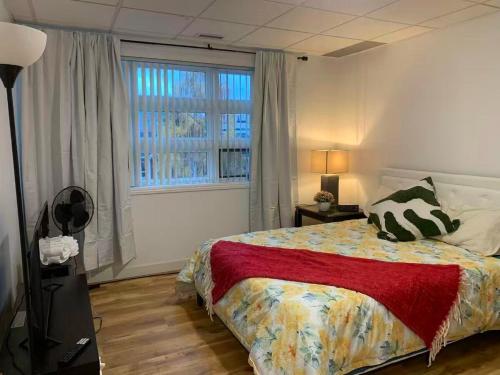 a bedroom with a bed and a large window at Four Seasons Garden in Whitehorse
