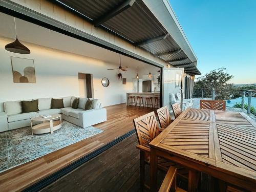 a living room with a couch and a table at Snapper Hideaway - Pet Friendly in Merimbula