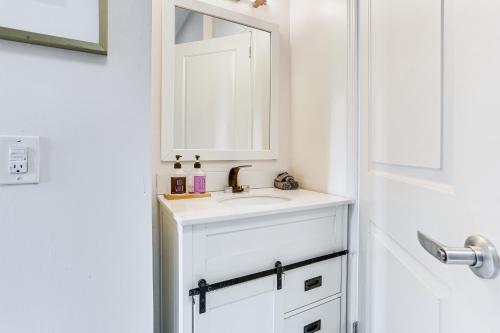 a white bathroom with a sink and a mirror at Explore and Work! Stylish Washington Heights Duplex in Newburgh