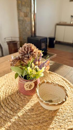 a flower arrangement in a basket on a table at Eco-Bungallow in Puerto Natales