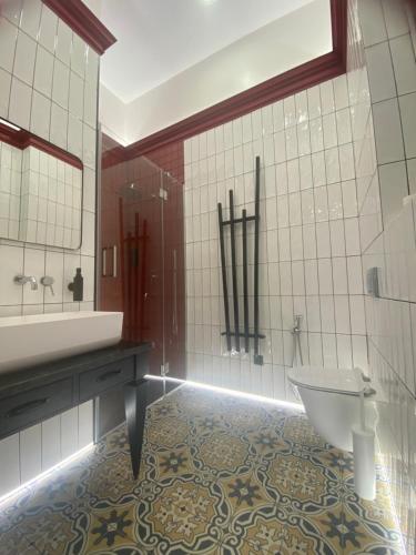 a bathroom with a tub and a toilet and a sink at Old city apart in Ivano-Frankivsʼk