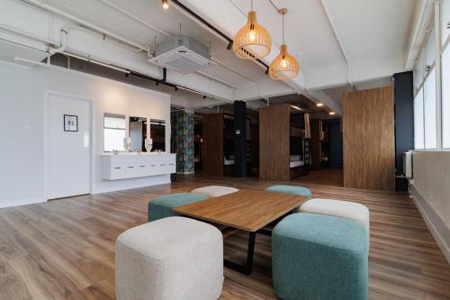 a meeting room with a wooden table and chairs at Haka House Auckland City in Auckland