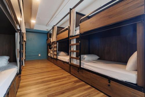 a hallway with four bunk beds in a room at Haka House Auckland City in Auckland