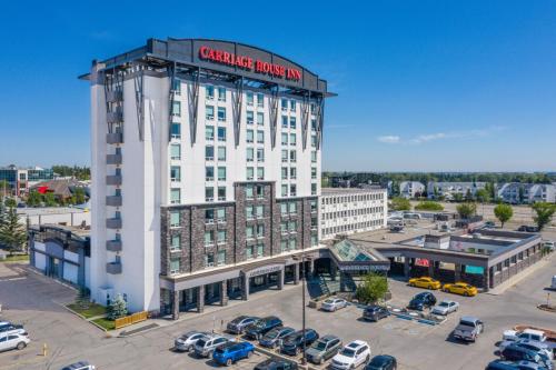 a large white building with a sign on it at Carriage House Hotel and Conference Centre in Calgary