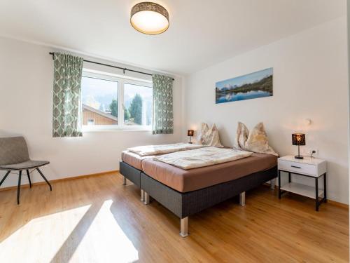 a bedroom with a bed and a window at JooP in Niedernsill