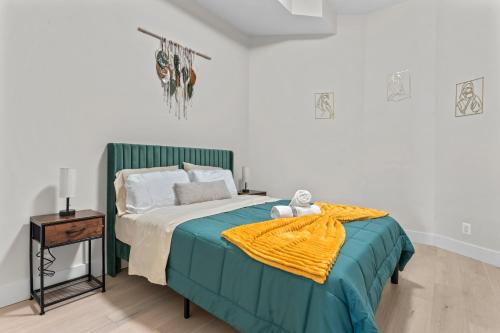 a bedroom with a bed with a yellow blanket on it at Lux 2Bedroom apartment in Washington DC Dupont in Washington