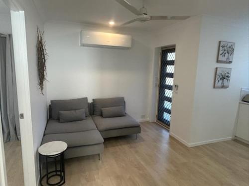 a living room with a couch and a table at Birkdale Granny Flat in Birkdale