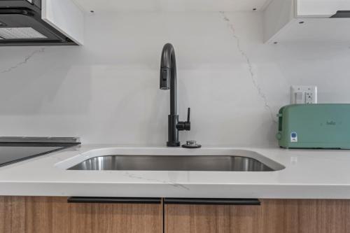 a kitchen sink with a faucet on a counter at Lux 2Bedroom apartment in Washington DC Dupont in Washington