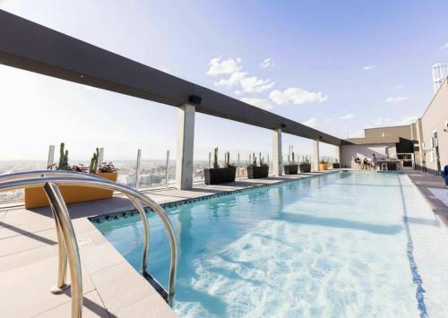 a swimming pool on the roof of a building at Boulevard Stays Highrise STU Sky Pool Parking Gym 22 in Phoenix