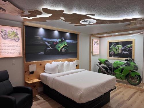 a bedroom with a bed and a motorcycle on the wall at Motorcycle Inn in Kodak