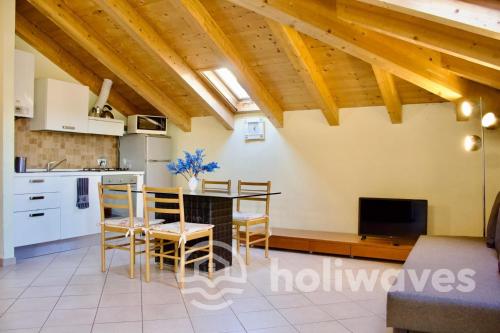 a living room with a kitchen and a table and chairs at Appartamento Ad Navalia in Varazze
