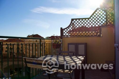 a balcony with a table and a fence at Appartamento Ad Navalia in Varazze