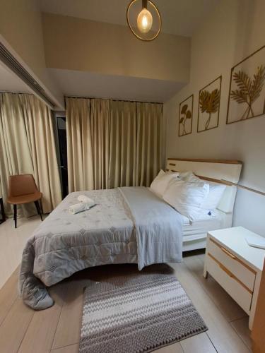 a bedroom with a bed and a nightstand and a bed sidx sidx sidx sidx at Mysuites2go24K Parksuites T2 in Manila