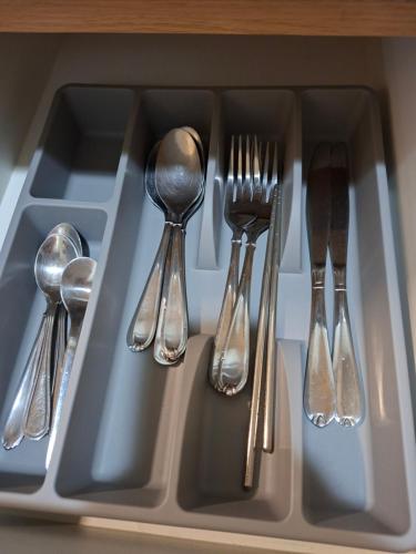 a tray with silver utensils in a drawer at Mysuites2go24K Parksuites T2 in Manila