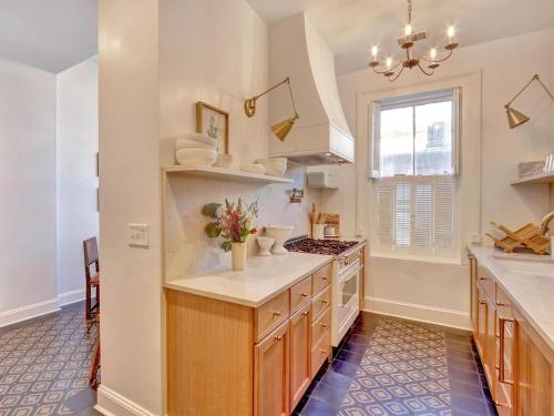 a kitchen with a sink and a stove at Elsewhere on Madison Square Main in Savannah