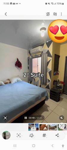 a picture of a bedroom with a bed with a smile sign at Suite confortável prox a COP 30 in Belém