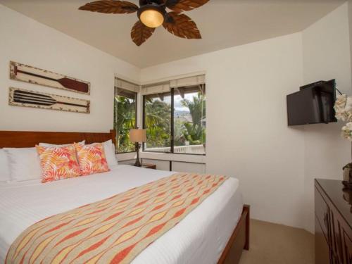 a bedroom with a bed and a ceiling fan at Wailea Grand Champions 84 in Wailea