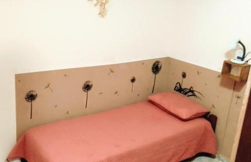 a bedroom with a bed with flowers on the wall at Teros in Caleta Olivia