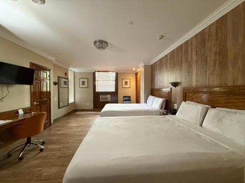 a hotel room with two beds and a desk at The Architect in Washington, D.C.