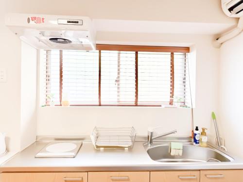 a kitchen with a sink and a window at Tsuruhashi 1F 9 min walk &3BR Apt for 6&Near Enba Natural Onsen&JR Direct to Namba, Nara & USJ in Osaka