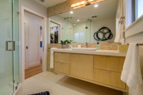 a bathroom with a sink and a large mirror at Sunset Beach in Encinitas