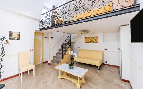 a living room with a staircase and a table at Capri Dreaming in Anacapri
