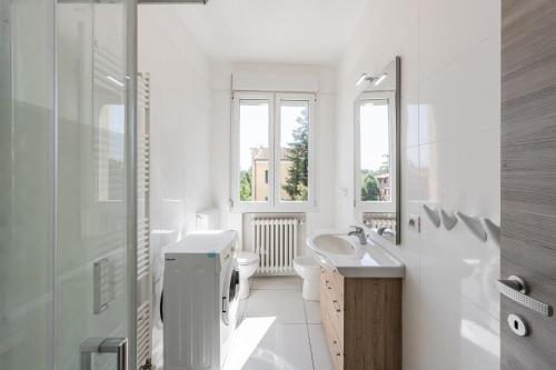 a white bathroom with a sink and a toilet at RUBIERA Residence House 