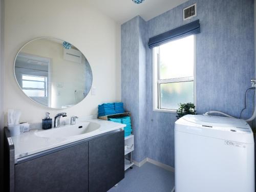 a bathroom with a sink and a mirror at VOGUE D, a private inn with a panoramic view - Vacation STAY 86199v in Isumi