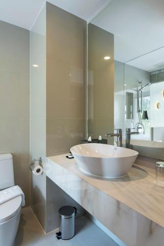 a bathroom with a large white sink and a toilet at Centara Life Phu Pano Resort Krabi in Ao Nang Beach